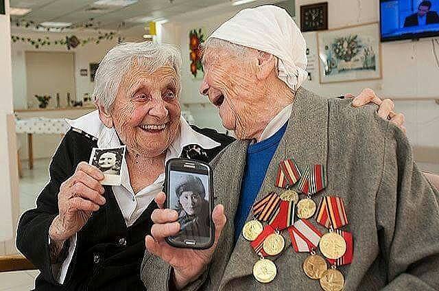 Δύο 90χρονες βετεράνες του Κόκκινου Στρατού ποζάρουν χαμογελώντας, όπως τότε...